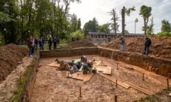 FILE - Archaeologists work at a site of the supposed burial place of French General Charles-Etienne Gudin in Smolensk, Russia, July 7, 2019.