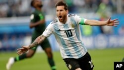 FILE - Argentina captain Lionel Messi celebrates after scoring the opening goal of his team during a match between Argentina and Nigeria, at the 2018 World Cup in St. Petersburg, Russia, June 26, 2018. 