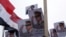 FILE - Posters of Army Chief General Abdel Fattah al-Sisi are seen as supporters of the army protest against ousted Islamist President Mohamed Morsi.