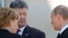 German Chancellor Angela Merkel, left, Russian President Vladimir Putin, right, and Ukrainian president-elect Petro Poroshenko, center, talk as they take part in the 70th anniversary of D-Day in Normandy, France on June 6, 2014. 