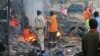 FILE - Somali soldier inspect wreckage of vehicles after a car bomb that was detonated in Mogadishu, Oct 28, 2017. 