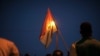 A protestor holds a Burkina Faso national flag during a protest against a recent coup in Ouagadougou, Burkina Faso, Sept. 21, 2015..