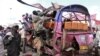 Residents look for survivors inside the wreckage of a passenger mini-bus (matatu) after it was hit by an explosion in the Eastleigh neighbourhood of Kenya's capital Nairobi, November 18, 2012.