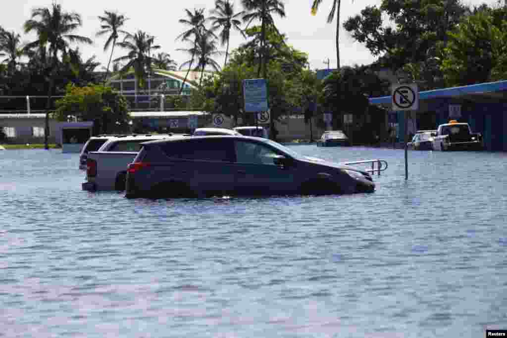 Cars are parked in a flooded lot of the airport in Acapulco, Sept. 18, 2013.