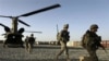 FILE - U.S. infantrymen from the 101st Airborne Division and Afghan army commandos exit a U.S. Army helicopter in Afghanistan's southern Kandahar province, Sept. 11, 2010.