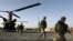 FILE - U.S. infantrymen from the 101st Airborne Division and Afghan army commandos exit a U.S. Army helicopter in Afghanistan's southern Kandahar province, Sept. 11, 2010.