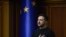 TOPSHOT - In this handout photograph taken and released by the Ukrainian Presidential Press Service on November 19, 2024, Ukraine's President Volodymyr Zelensky listens to Ukraine's national anthem prior to his address to members of the Ukrainian parliame