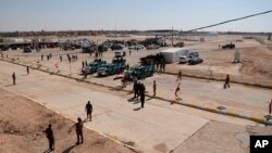 ກໍ​າ​ລັງ​ຮັກ​ສາ​ຄວາມ​ປອດ​ໄພ​ອີ​ຣັກ ແລະ​ບັນ​ດາ​ລົດ​ ທີ່​ເຫັ​ນ​ຢູ່ເຂດ​ຊາຍ​ແດນ ລະ​ຫວ່າງເມືອງ​ແກມ ຂອງ​ອີ​ຣັກ ແລະ​ເມືອງ​ບູກາ​ມາ​ລ ຊອງ​ຊິ​ເຣຍ ວັນ​ທີ 30 ກັ​ນ​ຍາ 2019