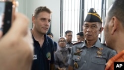Australian Matthew Norman, left, a member of the Bali Nine group serving life sentences for drug smuggling, talks with Indonesian representative council at Kerobokan prison in Bali, Indonesia Dec. 6, 2024. 