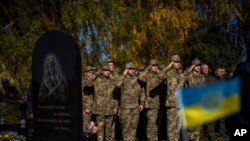 Wanajeshi wakitoa heshima wakati wa mazishi ya kanali Oleksiy Telizhenko, Bucha, Kyiv, Ukraine Okt 18, 2022. Oleksiy alitekwa nyara na wanajeshi wa Russia akiwa nyumbani kwake Bucha. mwili wake ulipatikana umezikwa msituni miezi sita baadaye, karibu na nyumbani kwake.