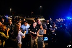 Louisiana Gov. Bobby Jindal, center, speaks with the media following a deadly shooting at the Grand Theatre in Lafayette, La., July 23, 2015.