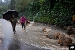 Water gushes down a road during a storm February 5, 2024, in Studio City, California. (AP Photo/Marcio Jose Sanchez)