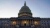 FILE - Lights shine from the U.S. Capitol dome in Washington, Dec. 18, 2019.