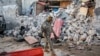 FILE - A soldier walks past rubble in the aftermath of an attack on the Afrik Hotel in Mogadishu, Somalia, Feb. 1, 2021. Al-Shabab claimed responsibility for the deadly assault. 