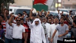Anti-government protesters affiliated with the opposition Al Wefaq movement, defying a ban on protest marches, shout anti-government slogans in the village of Sanabis, west of Manama, September 13, 2013.