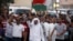 FILE - Anti-government protesters affiliated with Al Wefaq defy a ban on protest marches, shout anti-government slogans in the village of Sanabis, Sept. 13, 2013.