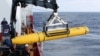 Crew aboard the Australian Defense Vessel Ocean Shield move the U.S. Navy's Bluefin-21 autonomous underwater vehicle into position for deployment in the southern Indian Ocean to look for the missing Malaysia Airlines flight MH370, April 14, 2014 in this h