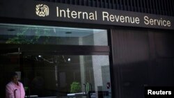 A woman walks out of the Internal Revenue Service building in New York, May 13, 2013.