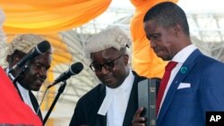FILE - The Patriotic Front's Edgar Lungu, right, is sworn in as president at an inauguration ceremony in Lusaka, Jan. 25, 2015.