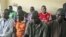 Men believed to be members of Islamist sect Boko Haram are suspected of being involved in a series of bomb attacks, wait for the start of a court session at the Wuse magistrate court in Nigeria's capital Abuja, September 13, 2011.