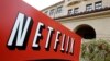 FILE - A sign points to Netfilx headquarters in Los Gatos, Calif. Netflix.