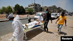 A patient is wheeled outside a COVID-19 hospital, amidst the spread of the coronavirus disease (COVID-19) in Ahmedabad, India, Apr. 19, 2021. 