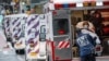 A patient arrives in an ambulance cared for by medical workers wearing personal protective equipment due to COVID-19 concerns outside NYU Langone Medical Center in New York, April 13, 2020.