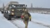 A service member of the Ukrainian Armed Forces runs near self-propelled multiple rocket launcher systems during drills in the Kherson region, Ukraine, in this handout picture released Feb. 1, 2022. (Ukrainian Armed Forces Press Service/Handout via Reuters)