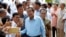 Cambodian Prime Minister Hun Sen, center, of ruling Cambodian People's Party, poses for a selfie with his party supporters after a voting in the Senate election at Takhmau polling station in Kandal province, southeast of Phnom Penh, Cambodia, Sunday, Feb. 25, 2018. Cambodia's ruling party is assured of a sweeping victory in the election of a new Senate after the only real opposition to it was eliminated. (AP Photo/Heng Sinith)