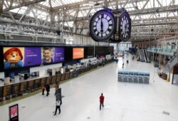 One of London's most famous rendezvous points is nearly empty under the Waterloo train station clock at 1800 in London, April 24, 2020.