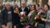 Afif Naeimi, a former leader of Iran's Baha'i community, is greeted by his wife and other loved ones following his Dec. 20, 2018, release from a decade of detention at Tehran's Evin prison.