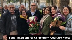 Afif Naeimi, a former leader of Iran's Baha'i community, is greeted by his wife and other loved ones following his Dec. 20, 2018, release from a decade of detention at Tehran's Evin prison.