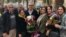 Afif Naeimi, a former leader of Iran's Baha'i community, is greeted by his wife and other loved ones following his Dec. 20, 2018, release from a decade of detention at Tehran's Evin prison.