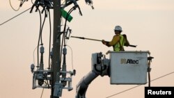 Crews work on power lines damaged by Hurricane Michael in Panama City Beach, Florida, Oct. 11, 2018. 
