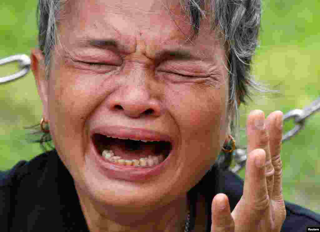 A mourner cries inside the Grand Palace after paying her respects to the late King Bhumibol Adulyadej in Bangkok, Thailand.