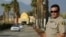 FILE - A police officer stands guard at the Dar Al Uloom Al Islamiyah-Amer mosque — where Syed Rizwan Farook was often seen — in San Bernardino, California, Dec. 4, 2015, two days after Farook and his wife shot 14 people to death at a Christmas party. 