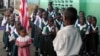 FILE - Liberian students are seen assembled to salute the flag at a Catholic school in the Liberian capital Monrovia.