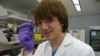 Jack Andraka, 16, with his pancreatic cancer sensor strip at the Johns Hopkins lab in Baltimore. (VOA/J. Taboh) 
