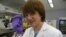 Jack Andraka, 16, with his pancreatic cancer sensor strip at the Johns Hopkins lab in Baltimore. (VOA/J. Taboh) 