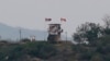 In this May 3, 2020, file photo, a North Korean flag flutters in the wind at a military guard post in Paju, at the border with North Korea.