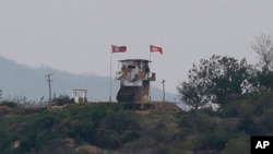 FILE - In this May 3, 2020, file photo, a North Korean flag flutters in the wind at a military guard post in Paju, at the border with North Korea. North Korea on Friday, May 8, slammed South Korea for staging what it called "reckless" military…