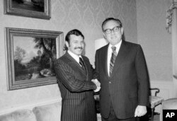 FILE - Abdelaziz Bouteflika, left, meets with U.S. Secretary of State Henry Kissinger at the U.S. State Department suite at the Waldorf Astoria Hotel Towers, Oct. 1, 1975.