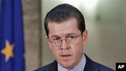 German Defense Minister Karl-Theodor zu Guttenberg speaks during a news conference where he announced his resignation in Berlin, Germany, over allegations he plagiarized his doctoral thesis, March 1, 2011