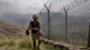 FILE - In this Aug. 3, 2021, photo, Pakistan Army troops patrol along the fence on the Pakistan-Afghanistan border.