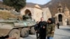 The monastery's abbot Father Hovhannes walks past a military vehicle of the Russian peacekeeping forces at the Dadivank, an Armenian Apostolic Church monastery, Nov. 15, 2020.
