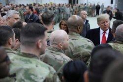 FILE - U.S. President Donald Trump and first lady Melania Trump greet U.S. troops at Ramstein Air Force Base, Germany, Dec. 27, 2018.