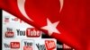 YouTube logos displayed on a laptop screen partially covered with Turkey&#39;s national flag in this photo illustration taken in Ankara March 27, 2014. 