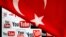 YouTube logos displayed on a laptop screen partially covered with Turkey&#39;s national flag in this photo illustration taken in Ankara March 27, 2014. 