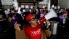 A supporter, foreground, of President Donald Trump yells as demonstrators chant outside Tom Bradley International Terminal during a protest, Jan. 30, 2017, at Los Angeles International Airport.