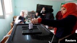 2014年1月14日，埃及妇女在投票站就是否批准新宪法投下自己的一票。